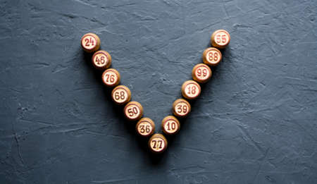 A Lotto Board game with wooden elements. Lotto barrels are lined with the letters W, V.の写真素材