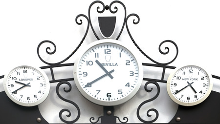 Three clocks next to each other marking the time in different cities around the world