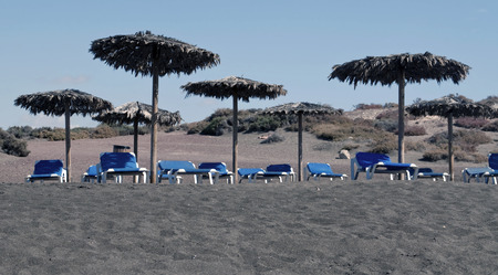 Several umbrellas and hammocks on the beach sandの写真素材