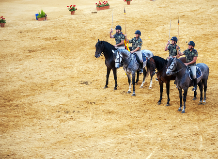 Four uniformed horsemen with lances and sabers.のeditorial素材