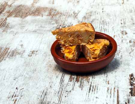 Spanish omelette surrounded by rustic background