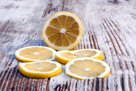 Sliced lemon surrounded by rustic backgroundの写真素材