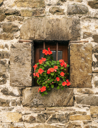 Facade of ancient house decorated with flowersの写真素材
