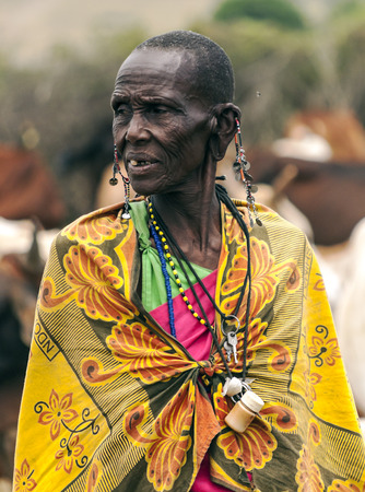 MASAI MARA,KENYA-MAY 14: Portrait on an African woman of Masai Mara tribe village looking to camera,review of daily life of local people,near Masai Mara National Parkのeditorial素材