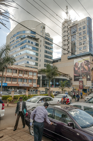 NAIROBI, KENYA - MAY 2014.Street scene in Nairobi. Cars and people in street. In background there are buildings, shops and advertising billboards.のeditorial素材
