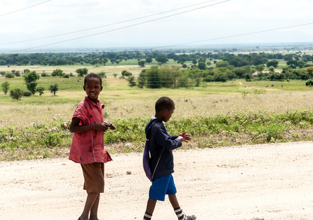 ARUSHA, TANZANIA - MAY 2014. Group of children in Africa face poor life conditions and health issues. However, they are curious, joyful and eager to play.のeditorial素材