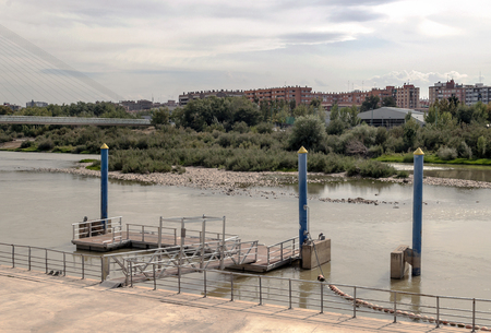 Ebro River in Zaragoza with buildings on one sideの写真素材