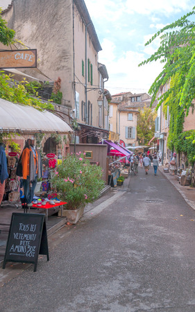GORDES, PROVENCE, FRANCE - SEPTEMBER 2014. Anonymous people walking through the streets of the medieval village of Gordes on a cloudy day.のeditorial素材