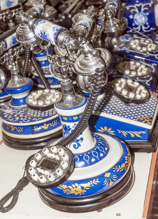 Old ceramic telephones of blue color in vertical.の写真素材
