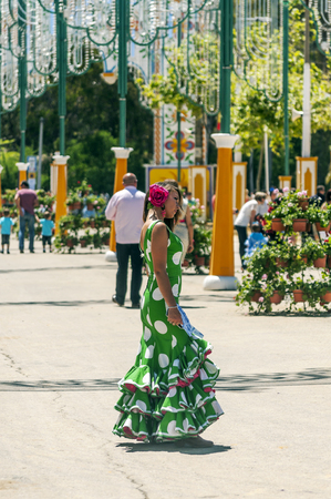 SEVILLA, ANDALUSIA, SPAIN-JULY 2015. Anonymous people dressed in flamenco at the Seville fair in Spain on a sunny dayのeditorial素材