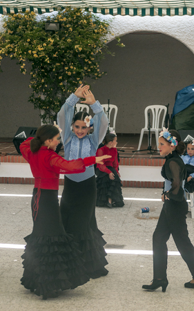 SEVILLA, ANDALUSIA, SPAIN-JULY 2015. Anonymous people dressed in flamenco at the Seville fair in Spain on a sunny dayのeditorial素材