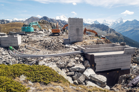 GRIEMENTZ, SWITZERLAND-SEPTEMBER 2015. Workers with cranes in the high mountains of the Saint Luc valley in the Swiss alps on a sunny day.のeditorial素材