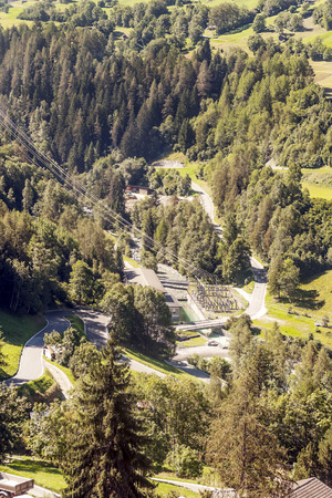 Wooden houses in the meadows of the Swiss Alps in the Saint Luc valley on a sunny day.の販売画像
