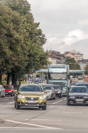 Munich, Germany-September 2015. Cars circulating on the German motorways on a sunny day. The roads are surrounded by mountains.のeditorial素材