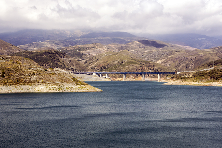 Lake in the Sierra Nevada mountains in the Spanish province of Granada on a cloudy dayの写真素材