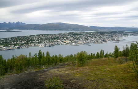 Bodo harbor on a cloudy day. BodÃ¸ is a municipality and a city of Norway, capital of the province of Nordland and the second most populated town in the Nord-Norge region, with 50 185 inhabitants in its municipality in 2015. BodÃ¸ is situated north of the polar circle Arctic and has midnight sun from June 4 to July 8の写真素材