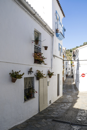 Street in a village of white houses in the Spanish province of Malaga called Casares on a sunny day.の写真素材