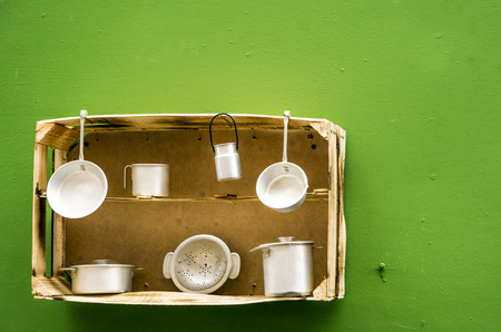 Aluminum kitchen utensils surrounded by green backgroundの写真素材