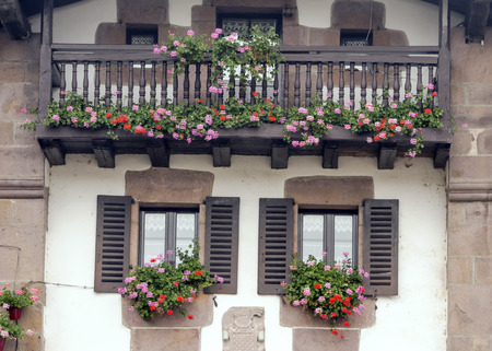 Balconies with flowers on the facade of a houseの写真素材