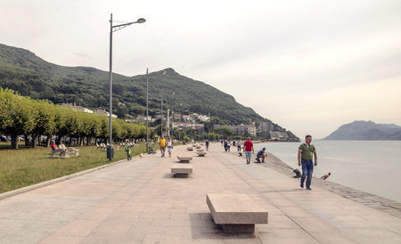 Castro Urdiales, Spain-Septemeber 2019. People and tourist walking in the promenade with big building in one side.のeditorial素材