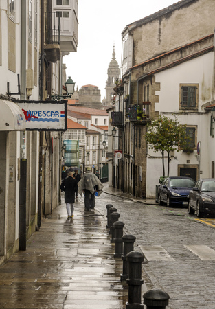 Santiago de Compostela, Spain-Octuber 2019. People walking in the street of the city in a raining day..のeditorial素材