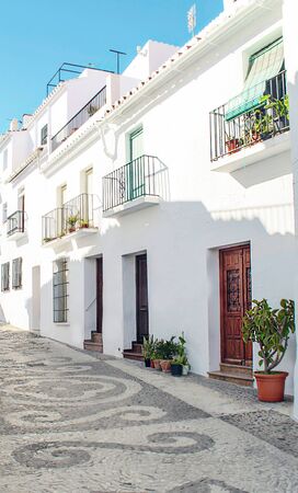 Street of white walls in a village of Andalusia called Frigiliana