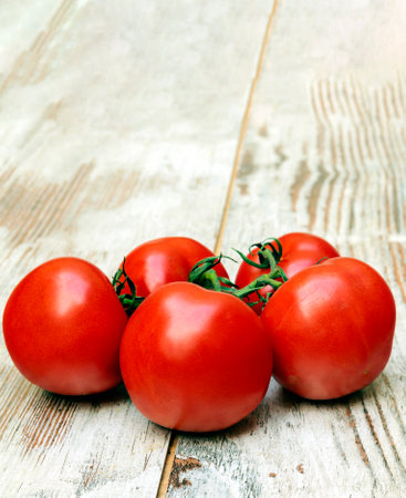 Tomatoes surrounded by rustic backgroundの写真素材