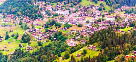 Wengen in the swiss alps surrounded by mountains in a cloudy day