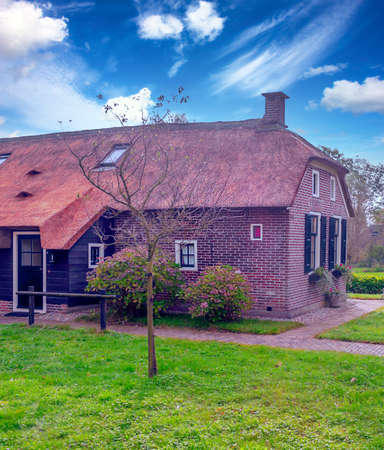 Giethoorn, village of Holland with canals and rural houses on a cloudy dayの写真素材