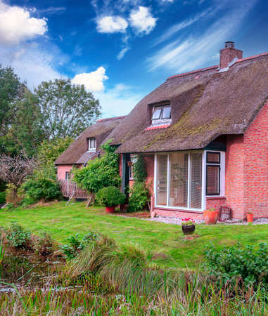 Giethoorn, village of Holland with canals and rural houses on a cloudy dayの写真素材