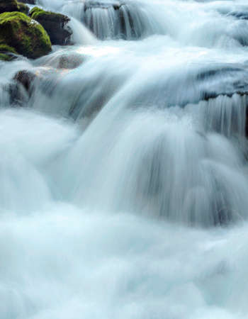 River in the mountains of the Swiss Alps in the Saint Luc valley on a sunny day.