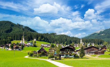 Village of Gosau with its wooden houses in the Alps of Austria on a cloudy day.