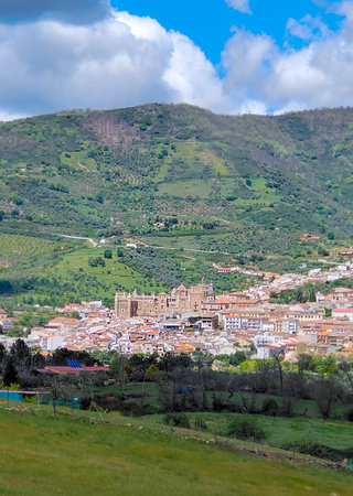Houses in Guadalupe in Caceres province surrounded by mountains in a cloudy dayの写真素材