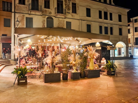 Bassano del Grappa, Italy - April 2023. Tourists in the streets of Bassano del Grappa in northern Italy at nightのeditorial素材