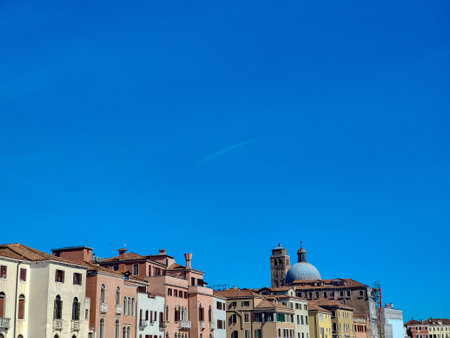 Street of Venice in the north of Italy in a sunny day. You can see the houses of the city.の写真素材