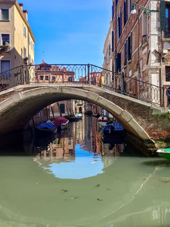 Canals of Venice in a sunny day with building in the street in the historic city.の写真素材