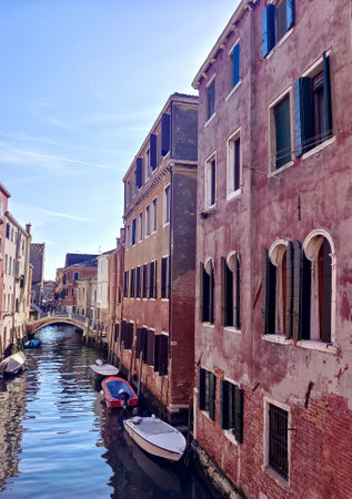 Canals of Venice in a sunny day with building in the street in the historic city.の写真素材