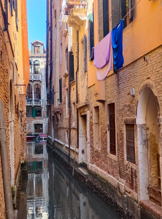 Canals of Venice in a sunny day with building in the street in the historic city.の写真素材