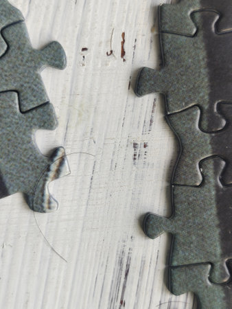 Jigsaw puzzle pieces on a wooden background. Selective focus.の写真素材