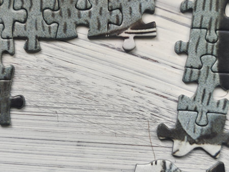 Jigsaw puzzle pieces on a wooden background. Place for text.の写真素材