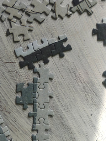 Jigsaw puzzle pieces on metal background, closeup of photo.の写真素材