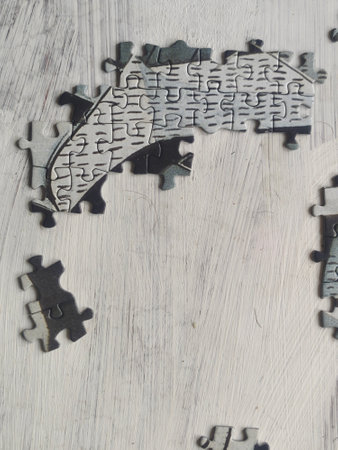 Jigsaw puzzle pieces on a wooden background. The concept of solving puzzles.の写真素材