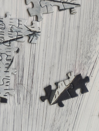 Puzzle pieces on wooden background. Close up. Selective focus.の写真素材