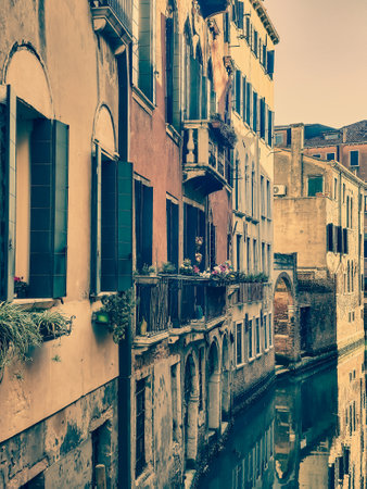 Canals of Venice in a sunny day with building in the street in the historic city.の写真素材