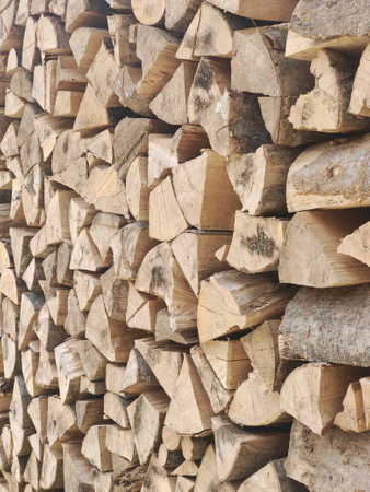Woodpile of chopped firewood ready for winter, closeup of photo