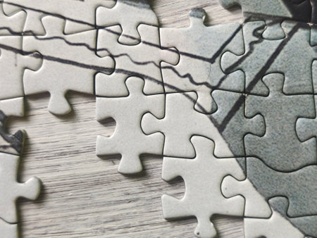 Jigsaw puzzle pieces on wooden table. Close up. Business conceptの写真素材