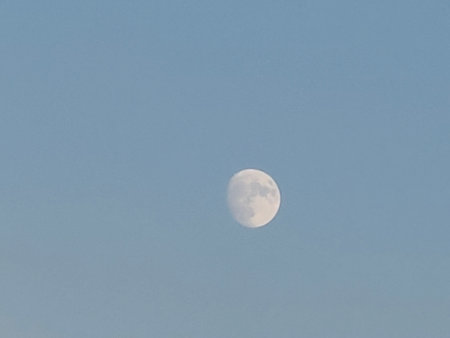 The moon in the blue sky in the morning, closeup of photoの写真素材