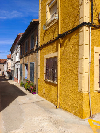 Spanish village with flowers in the street in a sunny dayの写真素材