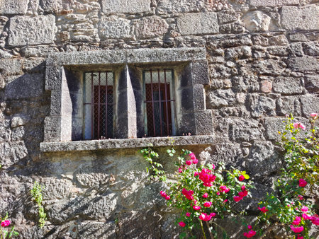 Flowers in the window of facade house in the south of Spain