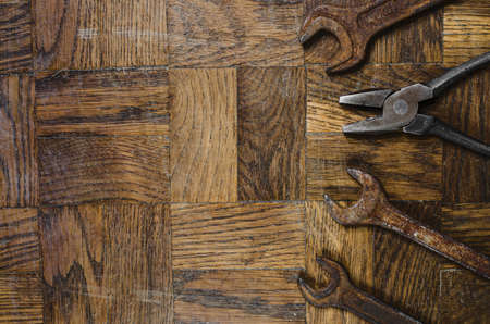 old rusty tools on wooden backgroundの写真素材